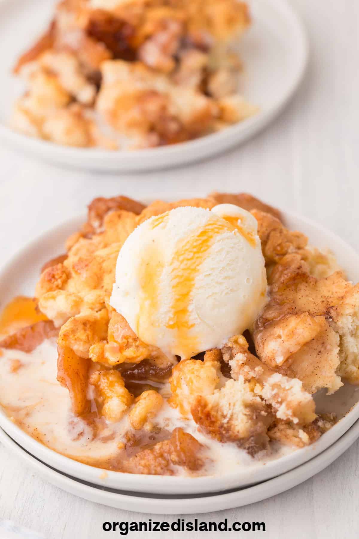 Easy Bisquick Apple Cobbler with ice cream on top.