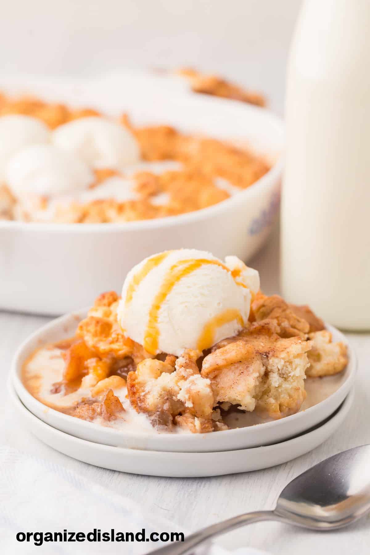 Easy Bisquick Apple Cobbler with ice cream in bowl.