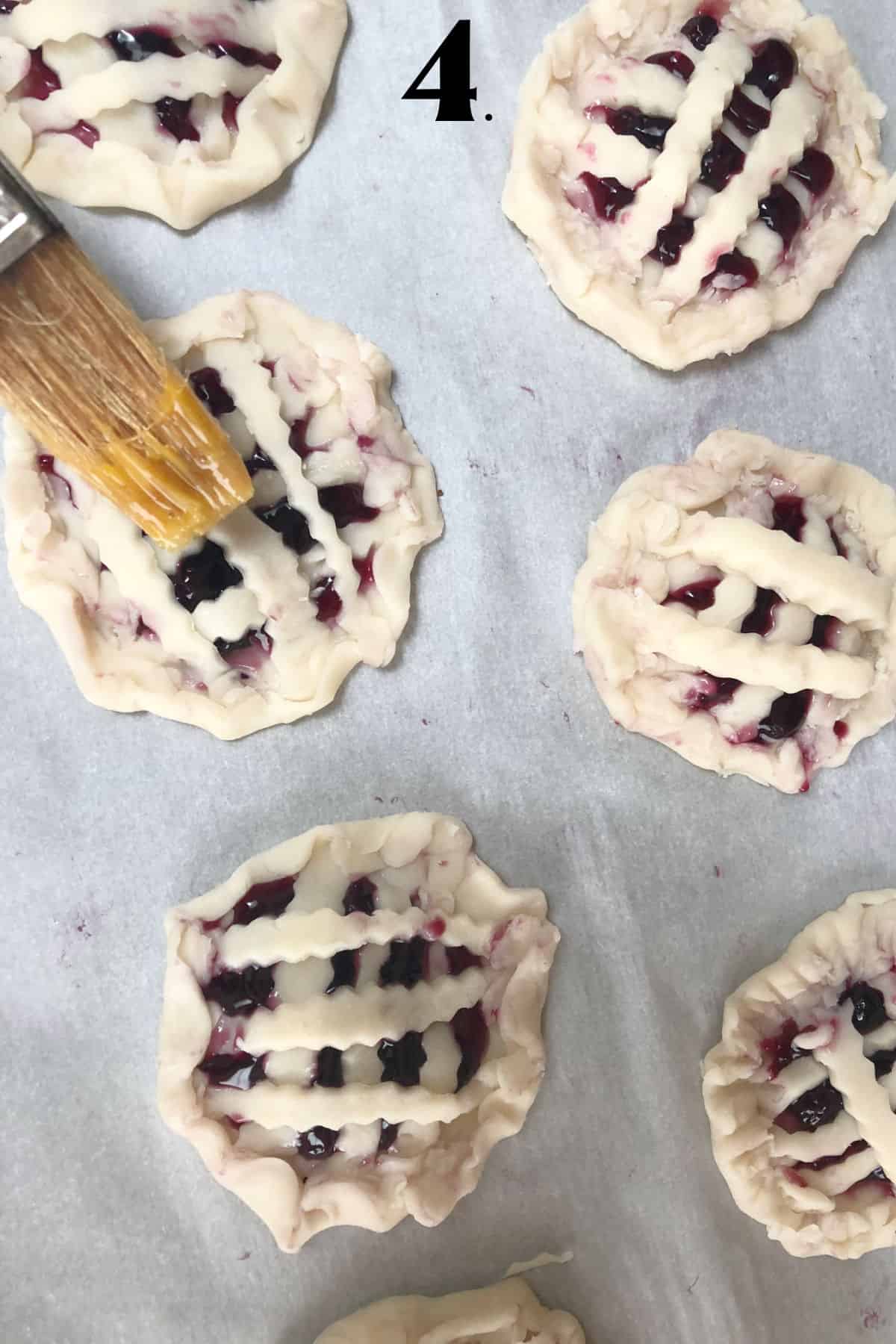 How to Make Blueberry Hand Pies Step 4 - brushing pies with egg wash.