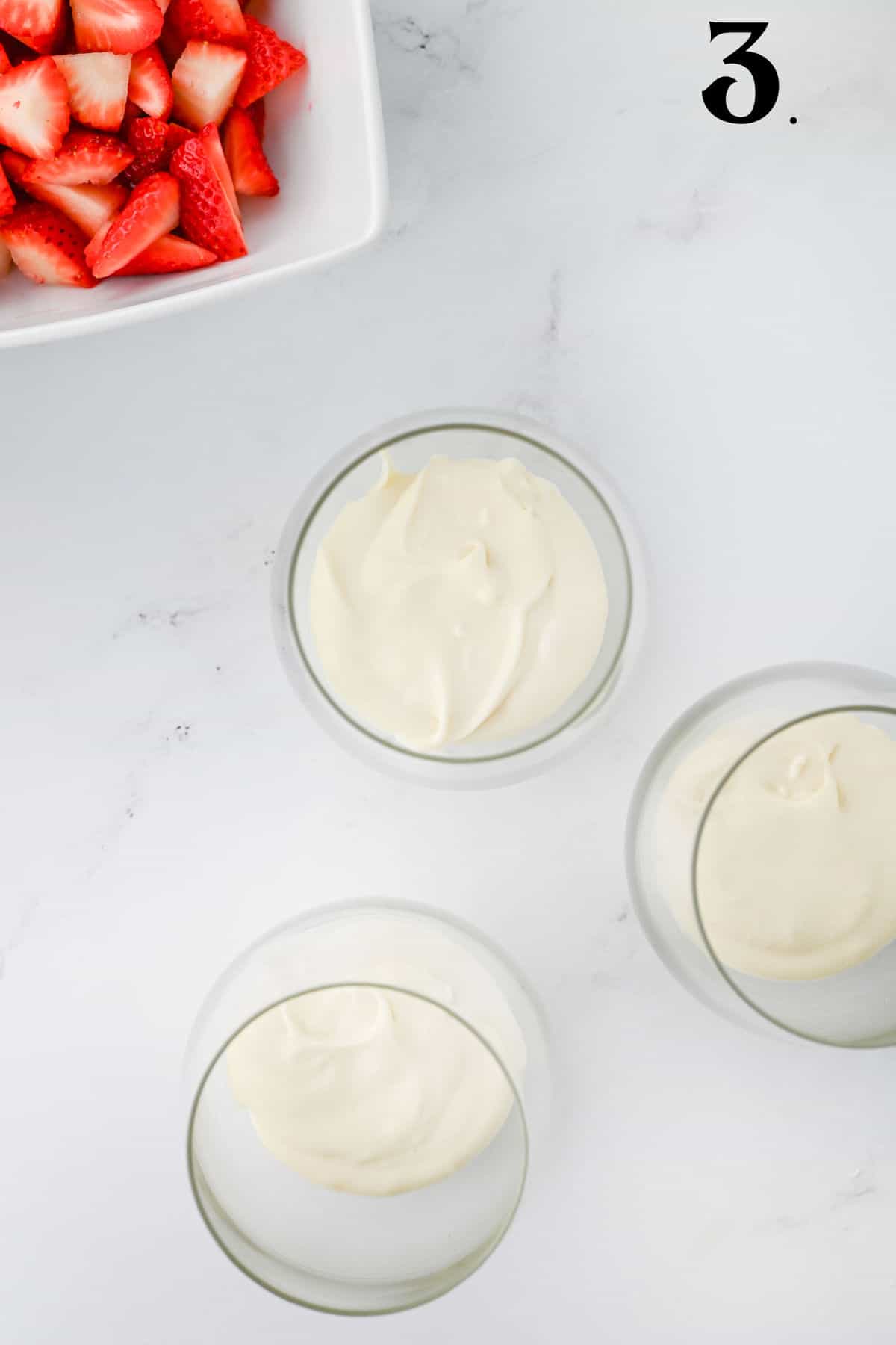 How to Make Strawberry Cheesecake Parfaits - Step 3 adding cream layer.