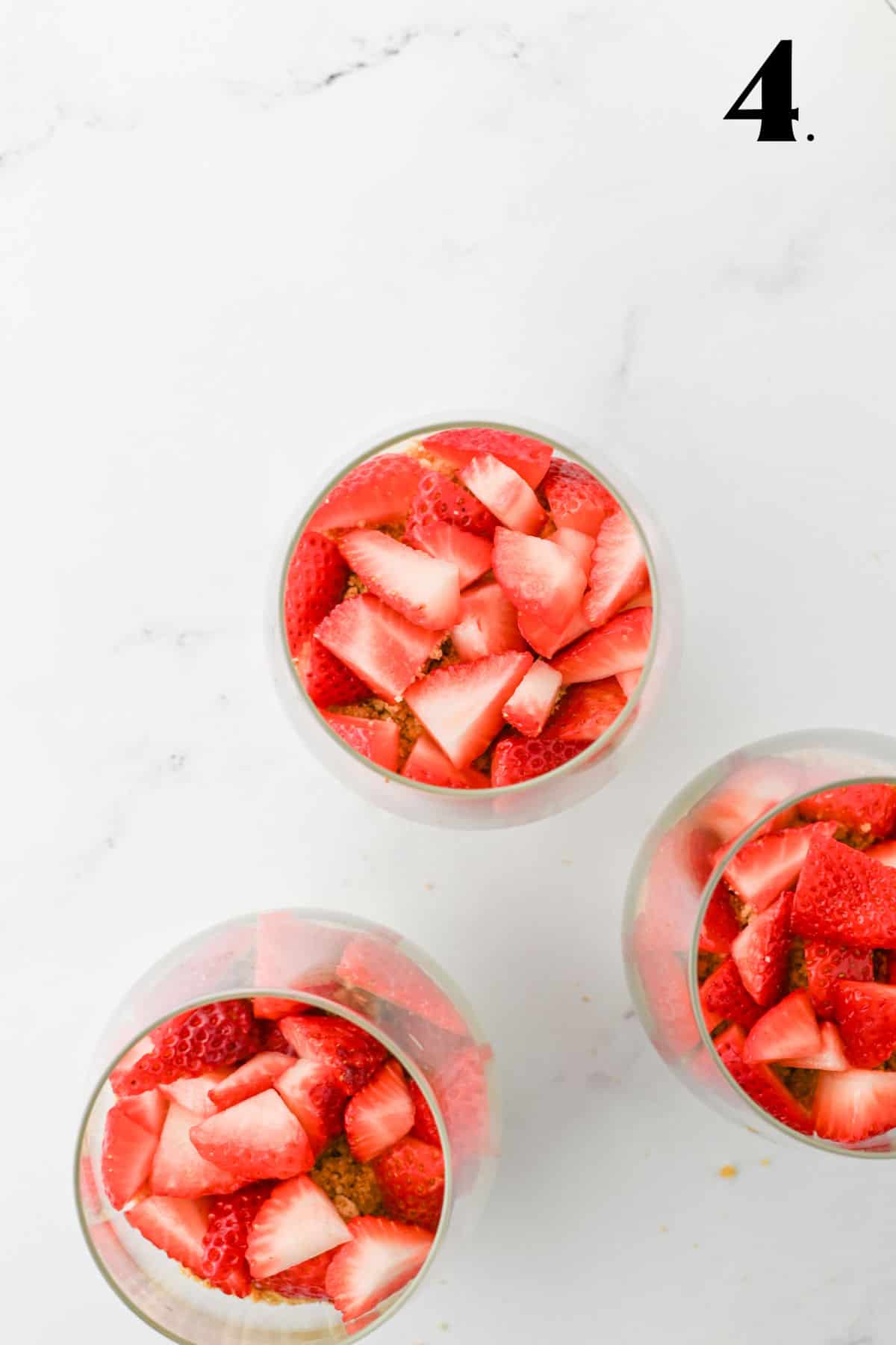 How to Make Strawberry Cheesecake Parfaits - Step 4 layering strawberries.