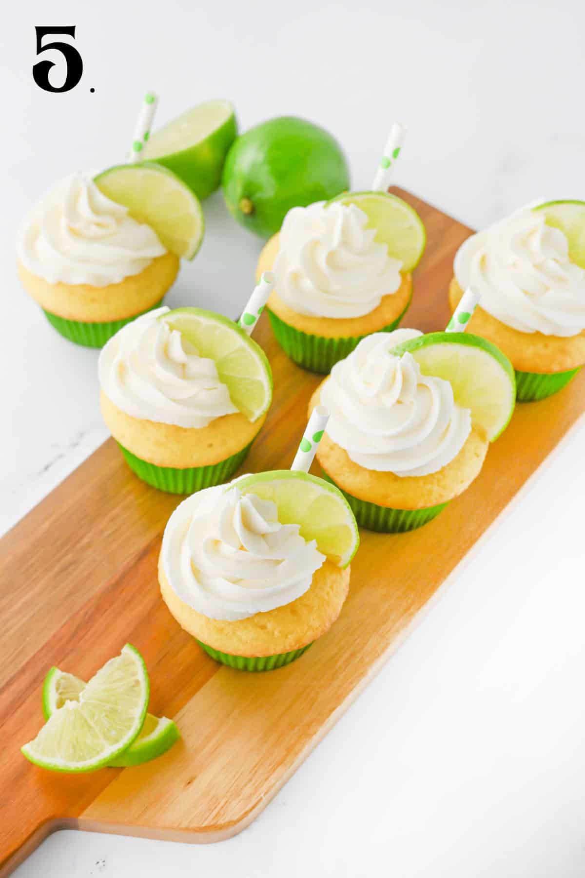 Tequila Margarita Cupcakes on board with lime.s