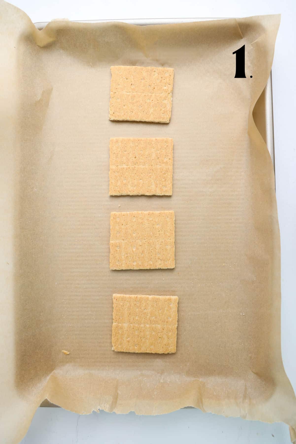 How to Make 4th of July S'mores Step 1 - crackers on parchmaent paper.