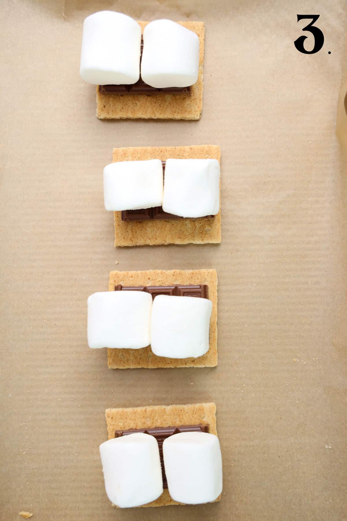 How to Make 4th of July S'mores Step 3 - marshmallows on chocolate pieces.