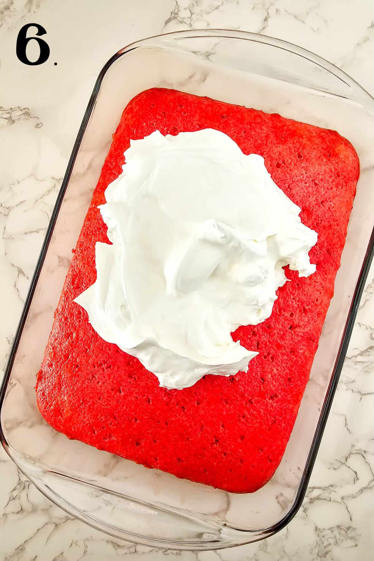 How to Make Cherry Poke Cake - Step 6 adding whipped topping.