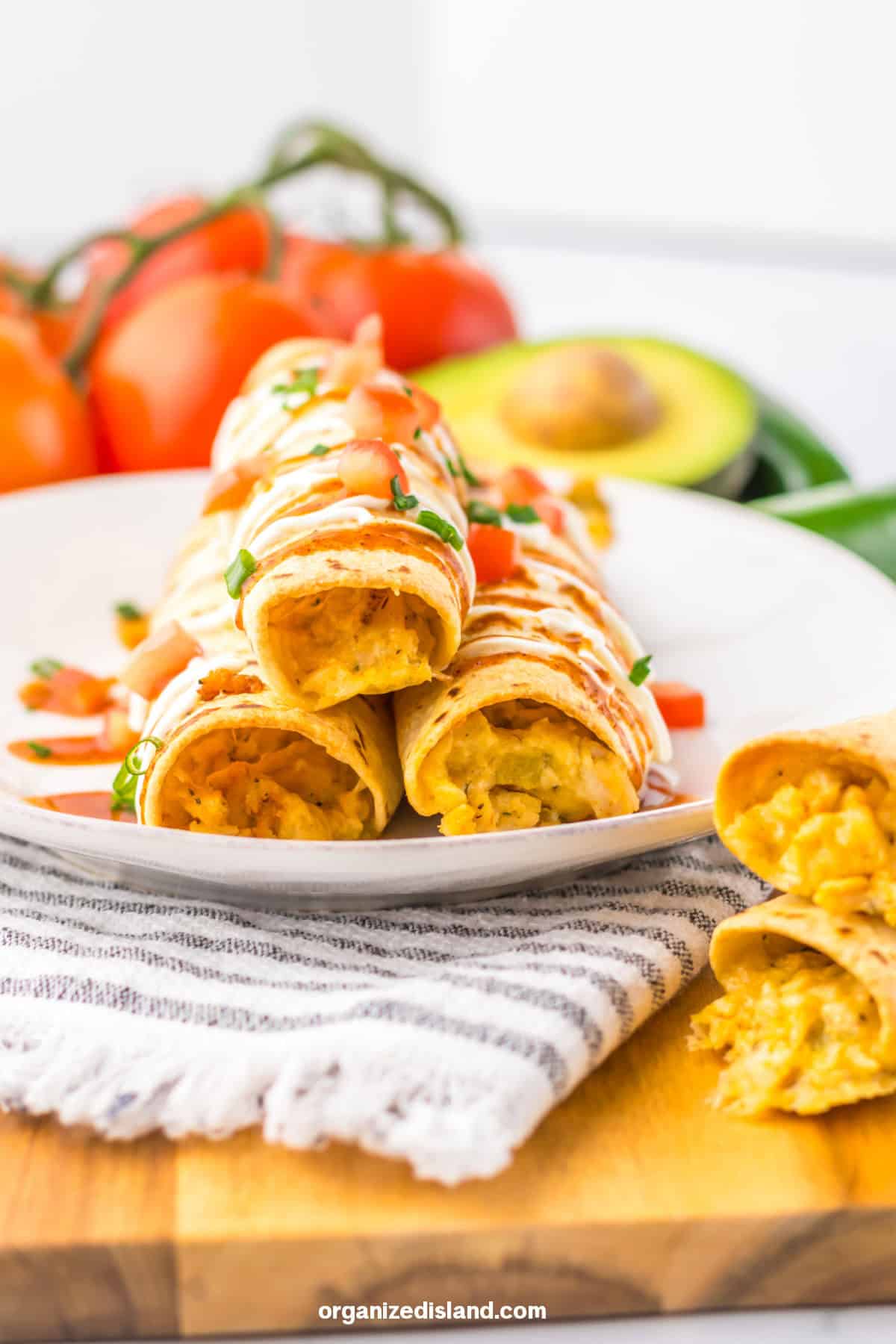 Chicken and Cheese Taquitos stacked on plate.