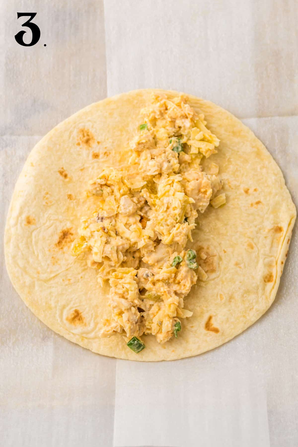 How to Make Chicken and Cheese Taquitos - Step 3 place chicken mixture on tortilla.